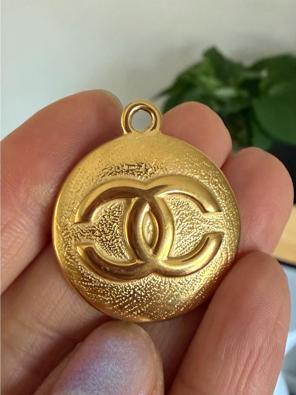 CHANEL Gold Textured Round zipper pull Pendant